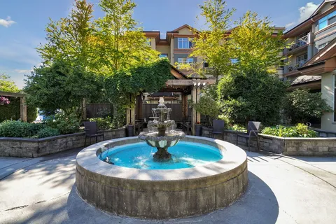 Courtyard fountain surrounded by seating and planting beds