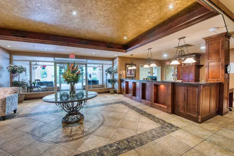 Lobby with a wooden reception desk and tiled floor