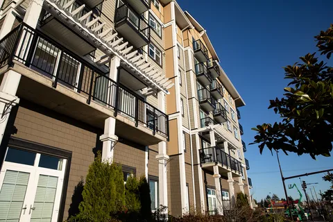 Building façade with balconies, a pergola and tall entrance windows