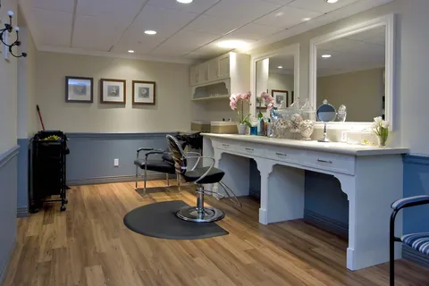 Salon with black chairs, mirrors and white counters