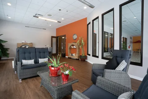Common lounge with armchairs and large windows.
