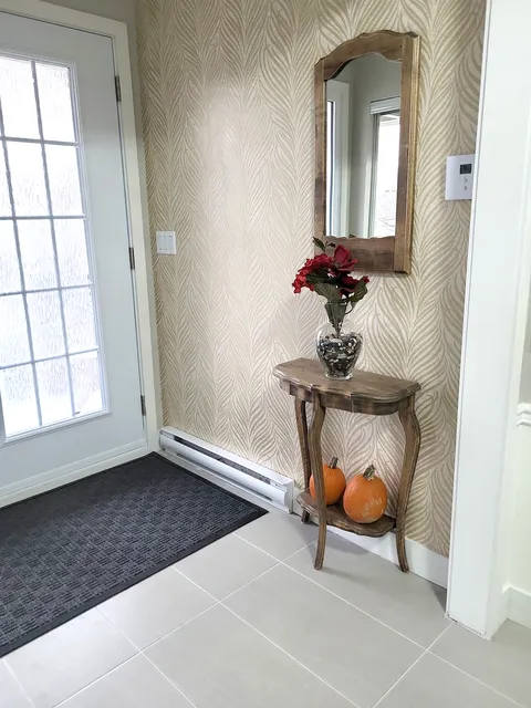 Interior entrance with a glass-panel door and console table.