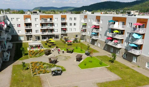 Aerial view of the residence around a landscaped courtyard.