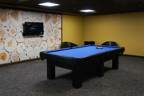 Billiards room with a blue pool table.
