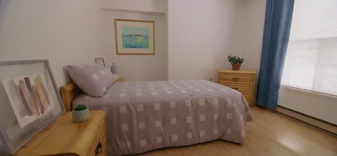 Bedroom with a bed, bedside furniture and a window.