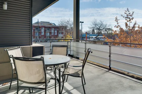 Covered balcony with a round table and four chairs