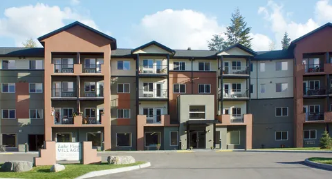 Residence facade with balconies, covered entrance and a curved driveway.
