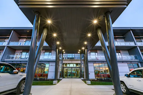 Entrance canopy with glass doors and a paved approach