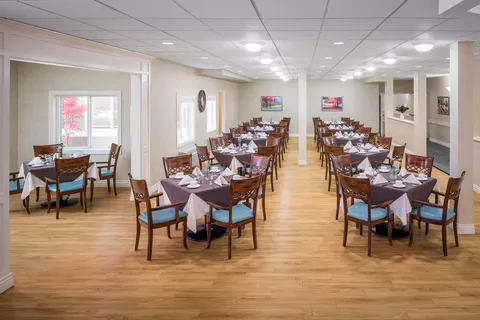 Dining room with set tables and wooden chairs