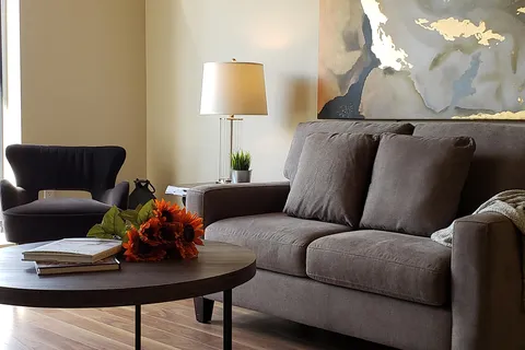 Suite sitting area with a sofa, armchair and coffee table.