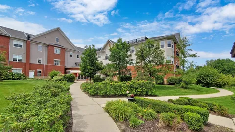 Residence building beside curving paths and planted beds