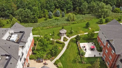 Aerial view of residence wings around a lawn, paths and gazebo