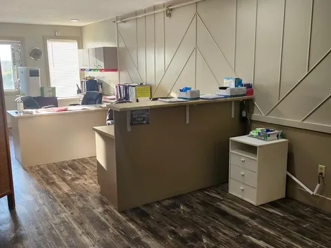 Nursing reception station with counters and a filing cabinet.