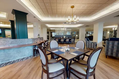 Bistro tables beside a counter and lounge seating.