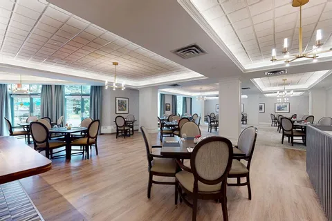 Dining room with round tables and large windows.