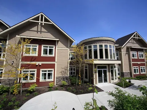 Exterior facade with a curved glass window section.