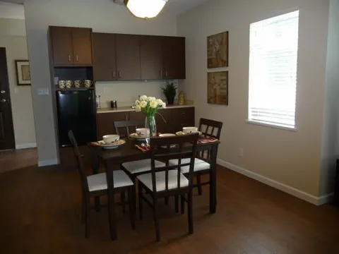 Suite kitchenette beside a small dining table.