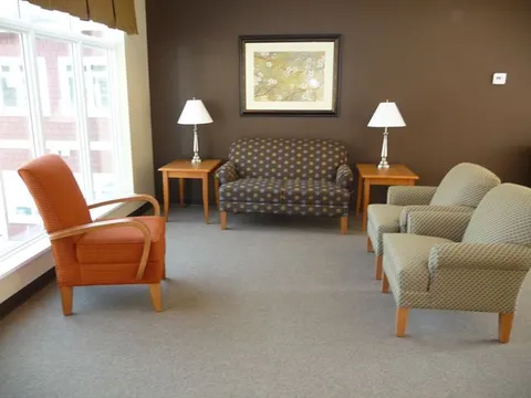 Sitting room with sofas, armchairs and side tables.