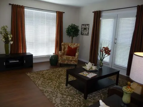 Suite living area with television, armchair and coffee table.