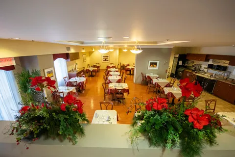 Dining room with set tables, wooden chairs and a buffet counter