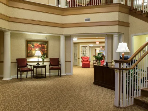 Lobby with a reception desk, seating and a staircase