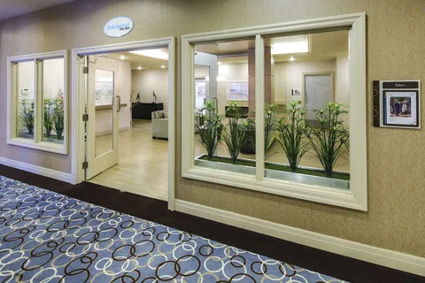 Spa entrance with glass doors, windows and plants.
