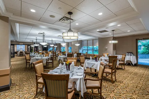 Dining room with round set tables and wooden chairs