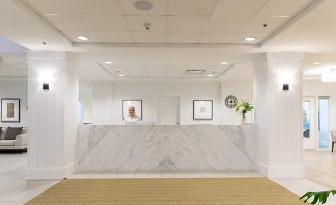 Reception counter in a bright entrance lobby.