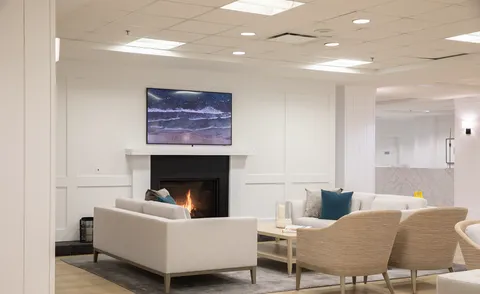 Lounge seating arranged around a fireplace.