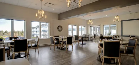 Dining room with set tables, chairs and large windows