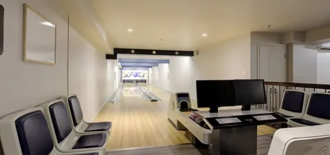 Bowling lane with chairs and scoring monitors