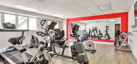 Fitness room with bicycles, treadmills and mirrored walls