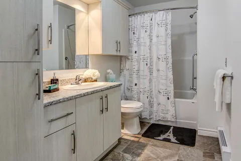 Bathroom with a vanity, toilet and bathtub.