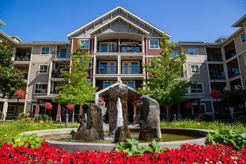 Four-storey residence with balconies, a stone fountain and flower beds