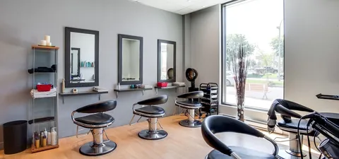 Hair salon with chairs, mirrors and hair dryers