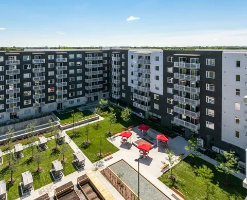 Residential buildings with balconies overlooking a landscaped courtyard