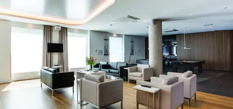 Sitting area with armchairs, side tables and large windows