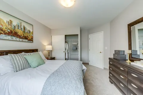 Bedroom with a double bed, dresser and open closet