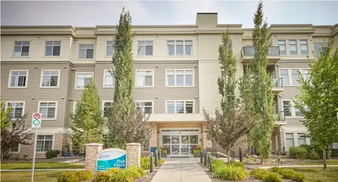 Multi-storey residence with trees beside its front entrance