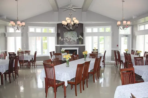 Dining room with round tables, chairs and a fireplace