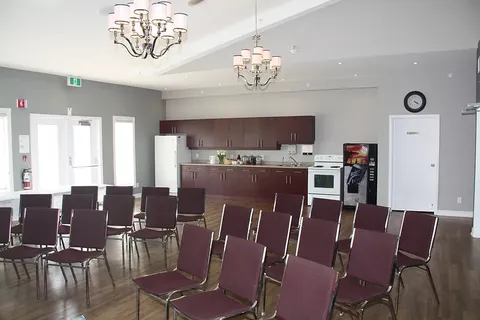 Room with rows of chairs and a kitchenette