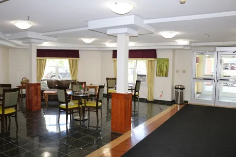Dining tables beside windows and a dark tiled floor.