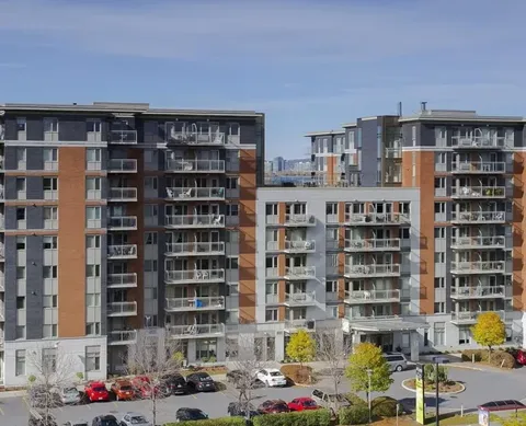 Multi-storey residence with balconies and parked cars outside