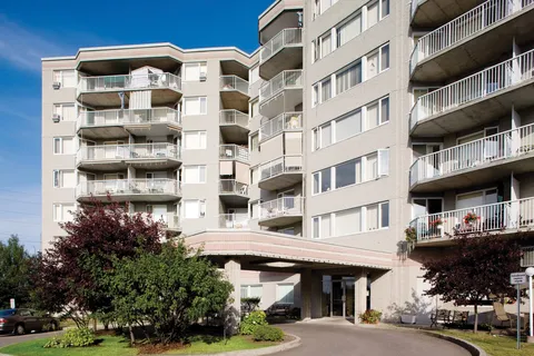 Multi-storey residence with balconies and a covered entrance.