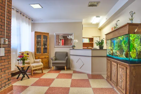 Reception area with seating and a large aquarium.