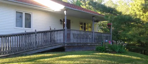 Residence exterior with a covered veranda and accessible ramp.
