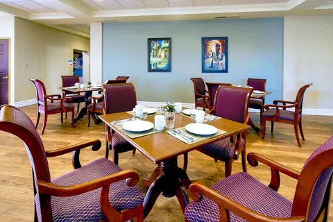 Dining room with set tables beside windows