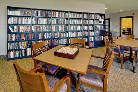 Library with bookshelves and tables for games or reading