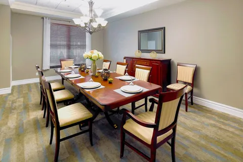Private dining room with a wooden table and sideboard