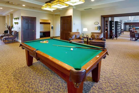 Games room with a pool table and lounge seating